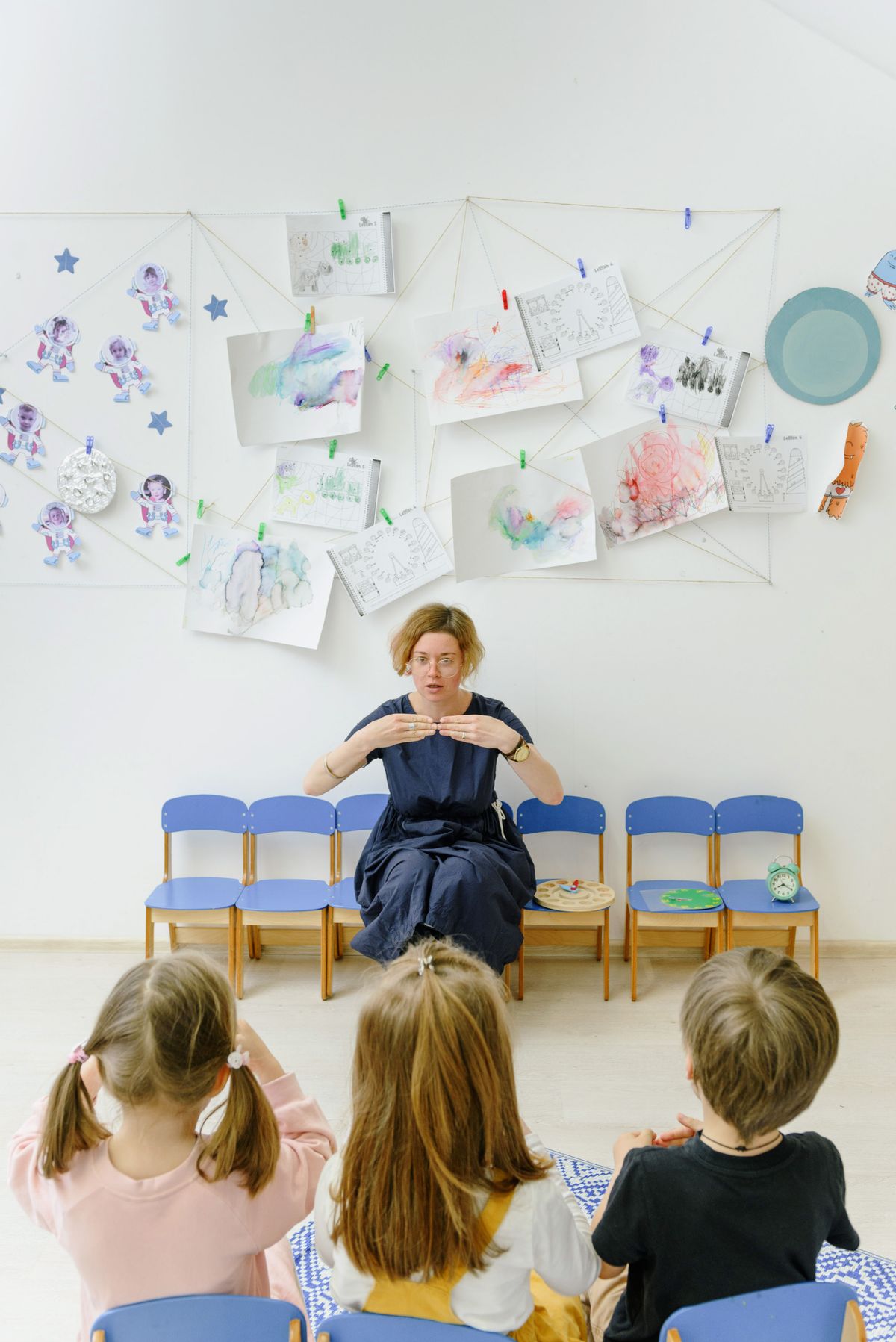 A teacher engaging closely with children during an activity