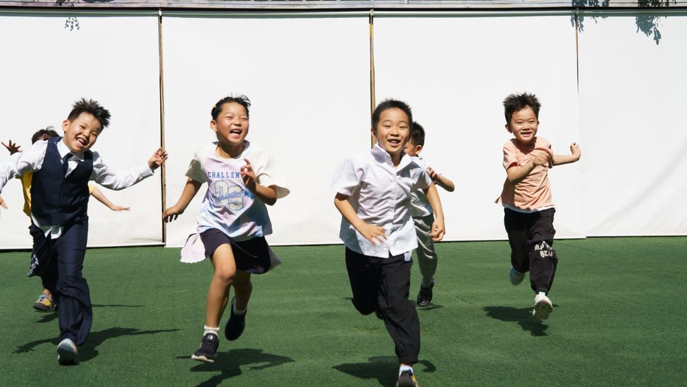 A group of children running together outdoors